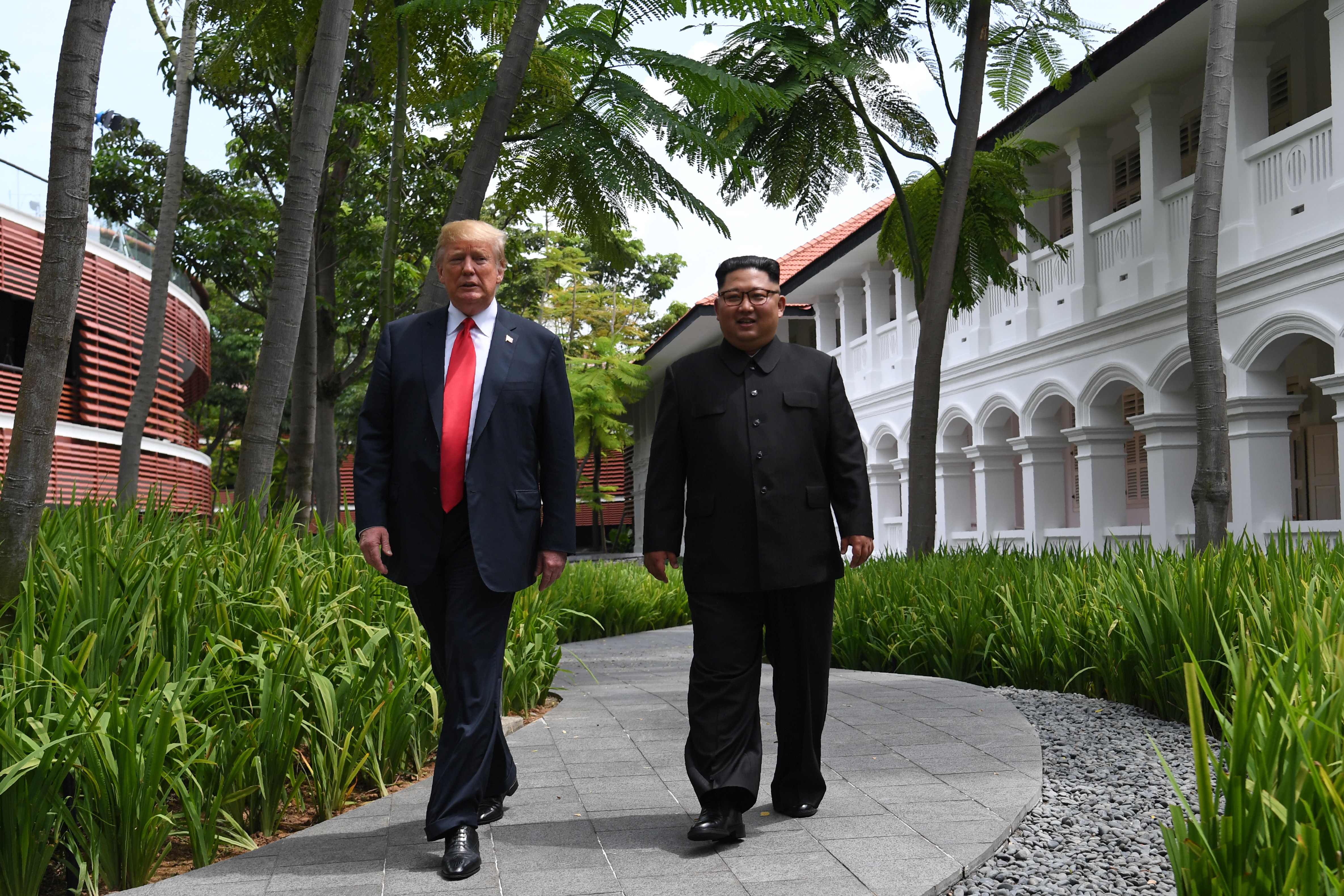 President Donald J. Trump walks with North Korean leader Kim Jong Un during a break in talks at their historic summit in Singapore on June 12, 2018. — Photograph: Saul Loeb/Agence France-Presse/via Getty Images.