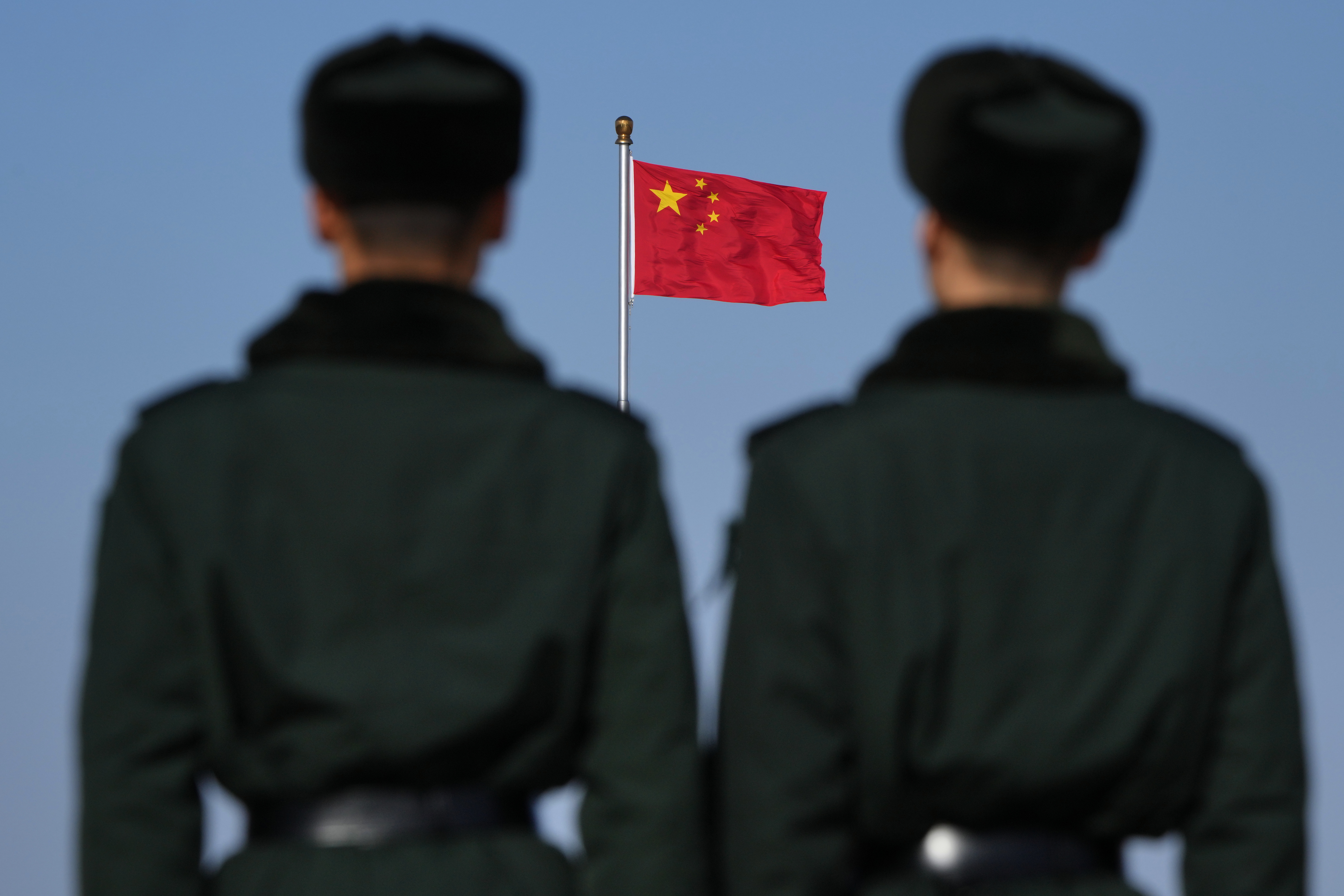 a group of people standing in front of a flag