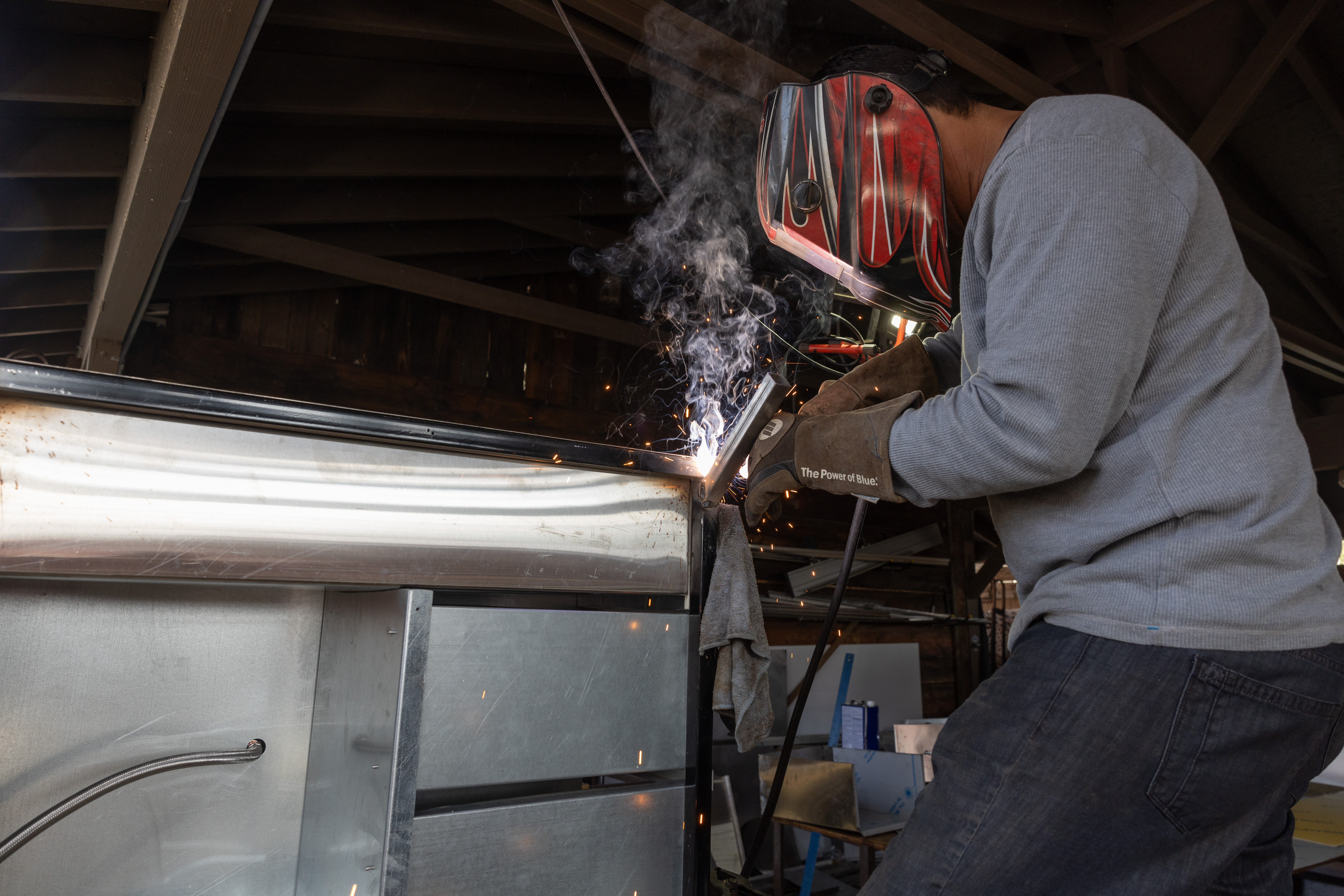 A welder builds a cart at the Food Truck Group in Sylmar on Friday. The company rents out food trucks and carts and helps vendors get permits.