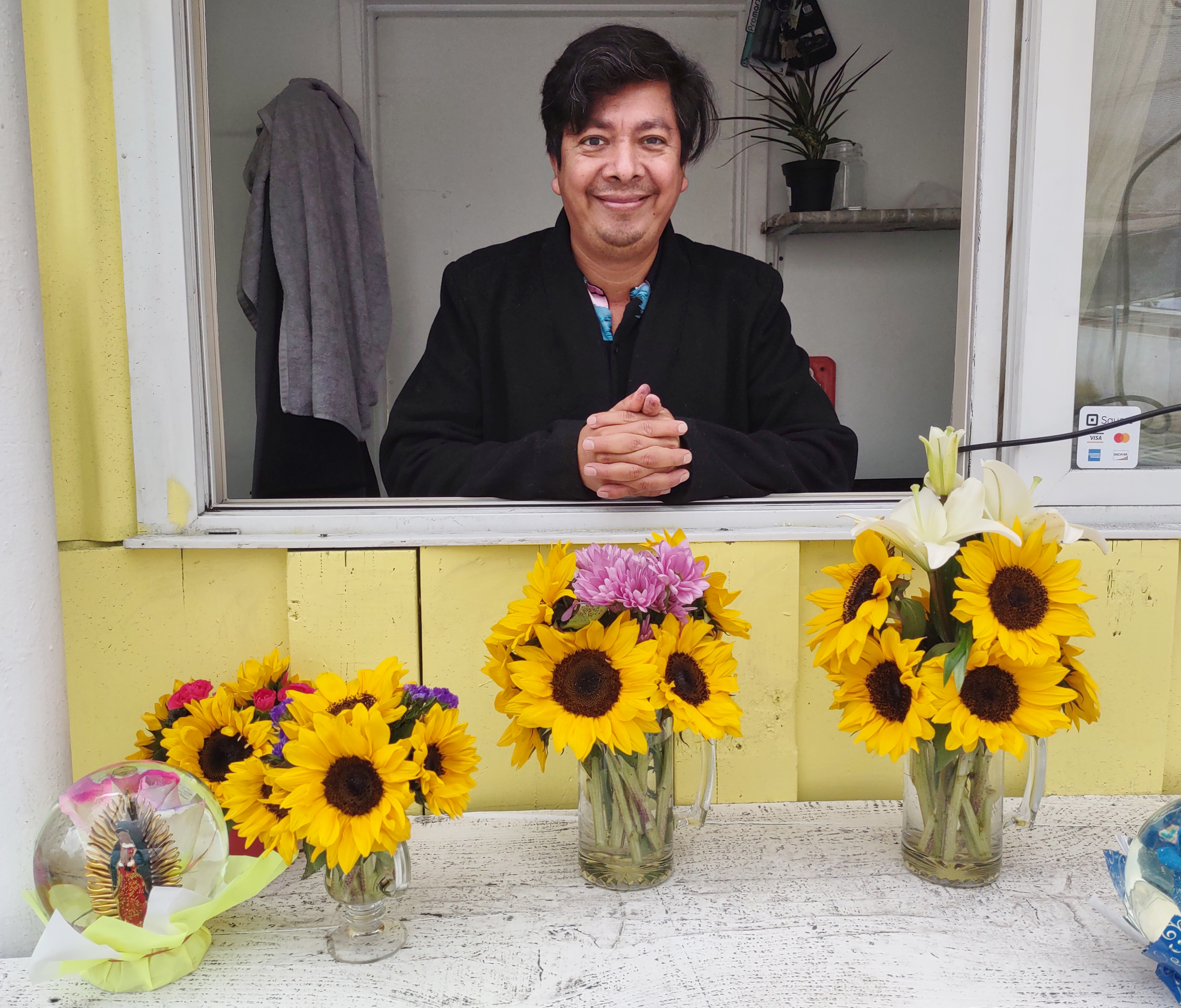 Simon Gonzalez offers holiday arrangements at his new flower stand, Gonzalez Flowers - Vimarsana News
